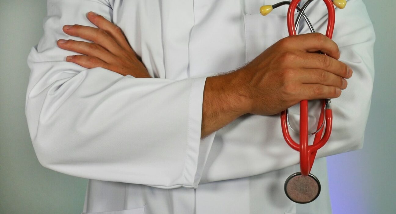 médecin tenant un stéthoscope rouge
